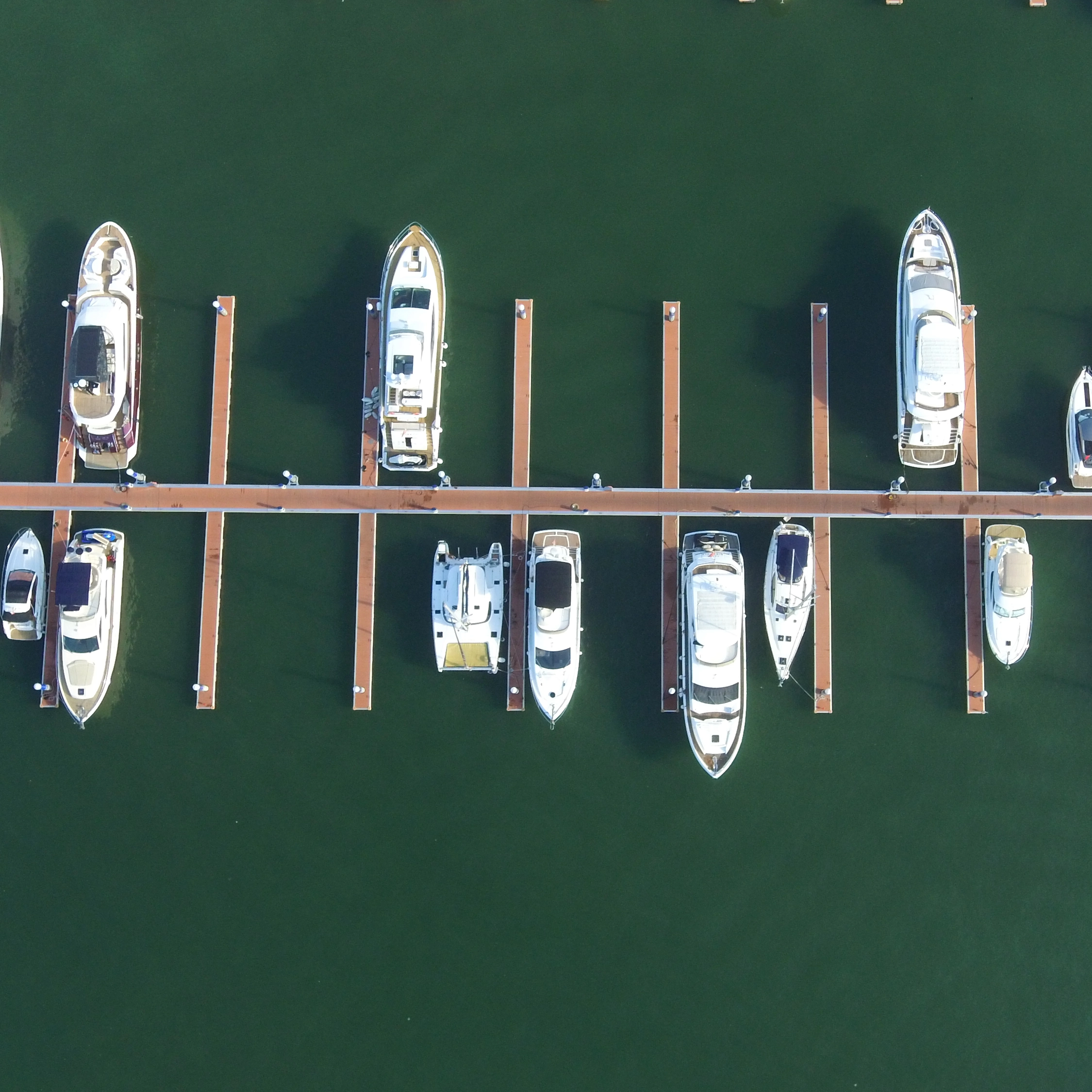 Marine and dock gangway handling extreme tidal changes over a floating pontoon system